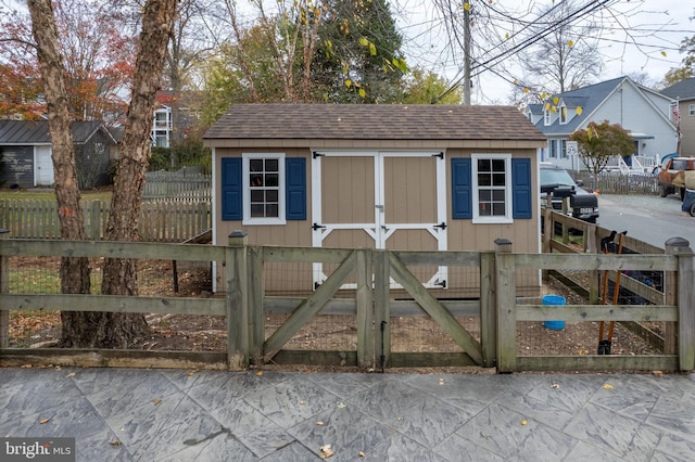 view of shed featuring fence