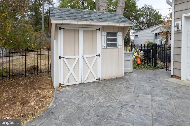 view of shed featuring fence