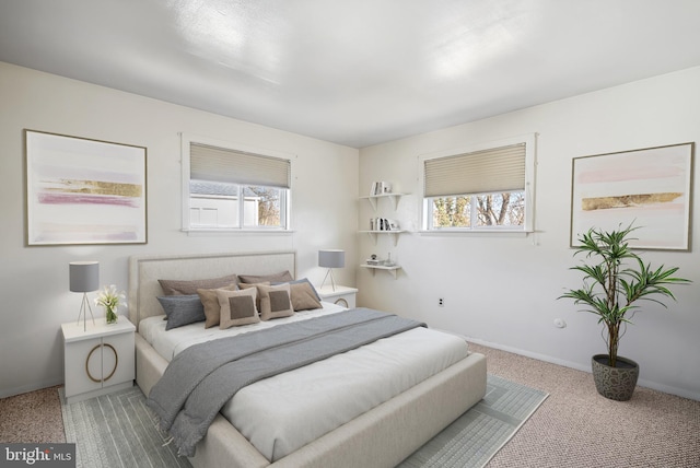 carpeted bedroom with baseboards and multiple windows