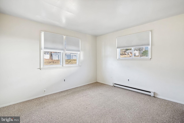 empty room with a baseboard heating unit and carpet flooring