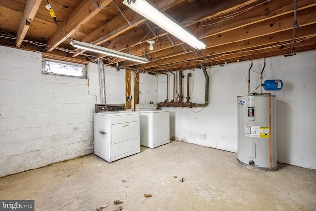 basement featuring water heater and washer and clothes dryer