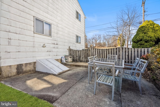 view of patio with outdoor dining space and fence