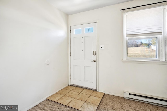 foyer featuring light tile patterned floors, baseboards, and a baseboard radiator