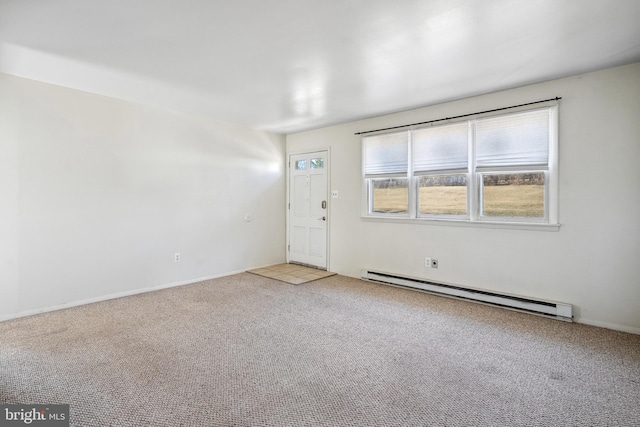 empty room with a baseboard heating unit and carpet flooring