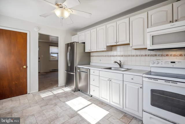 kitchen with a sink, stone finish flooring, tasteful backsplash, stainless steel appliances, and light countertops