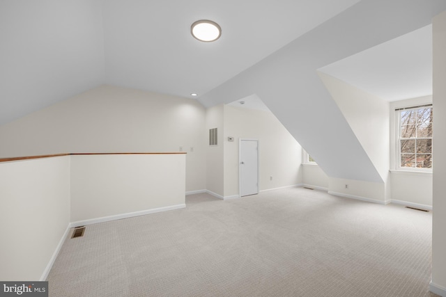 bonus room featuring lofted ceiling, carpet, visible vents, and baseboards