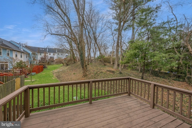 wooden deck with a residential view and a lawn