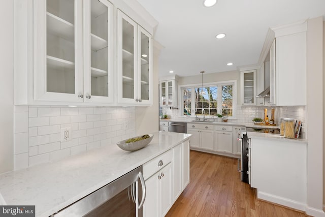 kitchen featuring white cabinetry, a sink, wine cooler, light wood-style floors, and stainless steel dishwasher