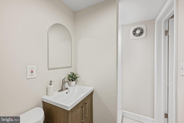 bathroom featuring visible vents, toilet, and vanity