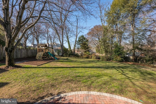 view of yard with fence and a playground