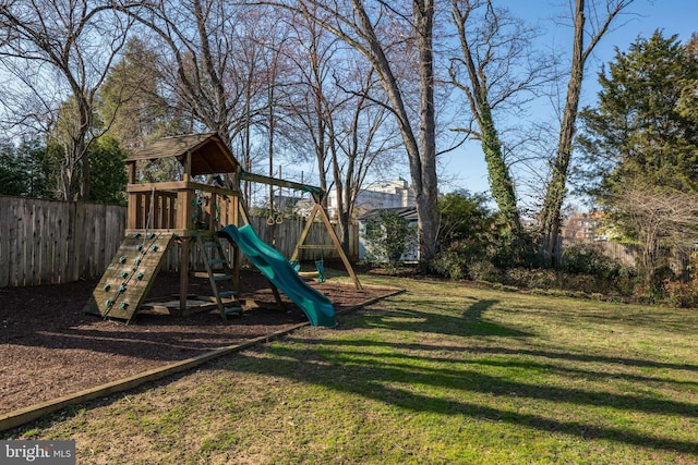 view of jungle gym featuring a lawn and fence