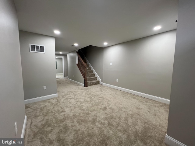 basement featuring baseboards, visible vents, stairway, carpet flooring, and recessed lighting