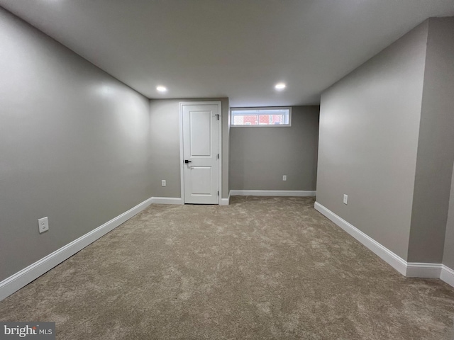 below grade area with carpet floors, recessed lighting, and baseboards