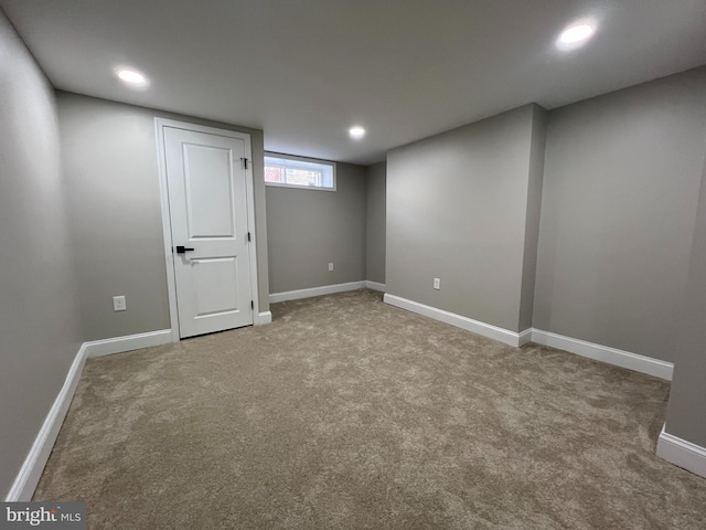 below grade area with carpet floors, recessed lighting, and baseboards