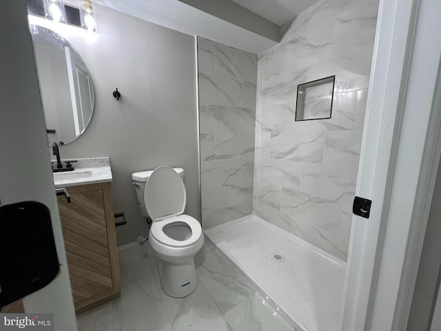 full bath featuring toilet, vanity, baseboards, marble finish floor, and a shower stall