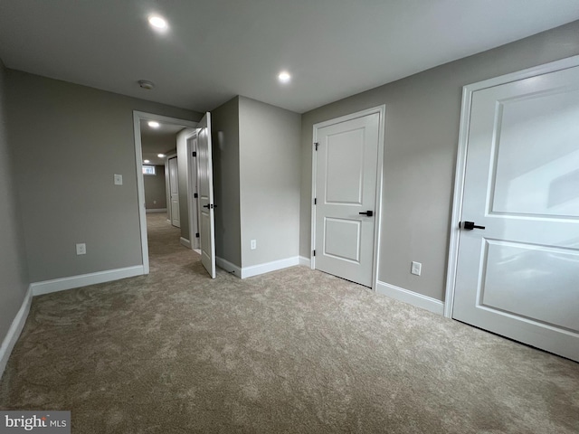 unfurnished bedroom featuring recessed lighting, baseboards, and light colored carpet