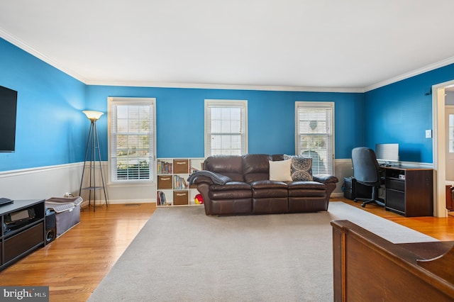 living area featuring wood finished floors and ornamental molding