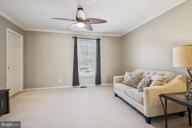 living area with a ceiling fan, light colored carpet, baseboards, and ornamental molding