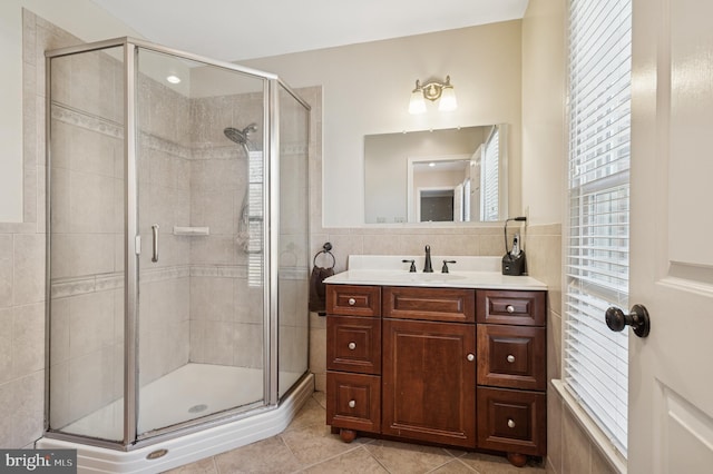 bathroom featuring a wealth of natural light, tile patterned floors, and a stall shower