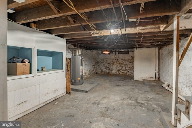 unfinished basement featuring gas water heater