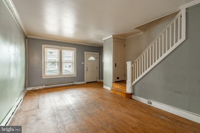 foyer entrance with a baseboard radiator, baseboard heating, ornamental molding, wood finished floors, and stairs