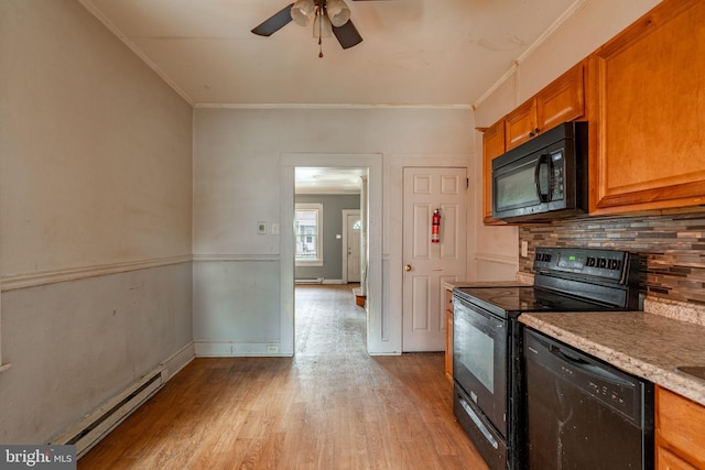 kitchen with light wood finished floors, baseboard heating, brown cabinets, black appliances, and tasteful backsplash