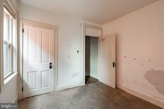 unfurnished bedroom featuring baseboards and carpet flooring