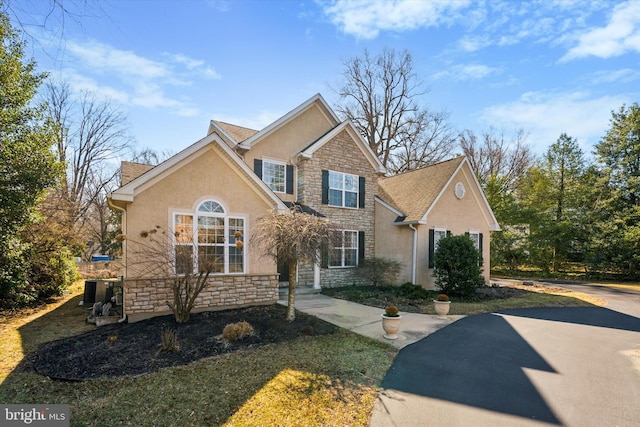 view of front of house with stucco siding and stone siding