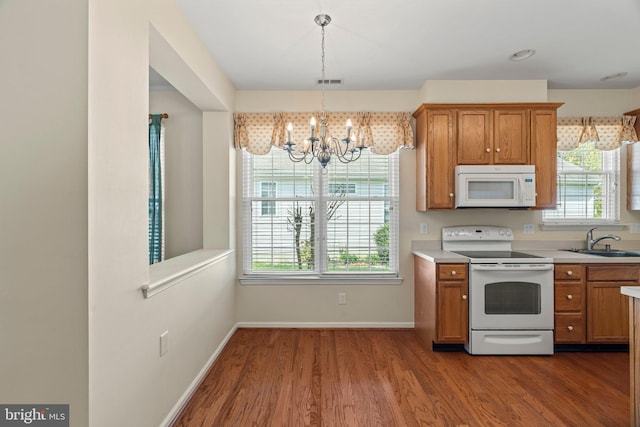 119 Glengarry Ln, Hainesport, NJ 08036 - kitchen featuring white appliances, a sink, a chandelier, and brown cabinetry