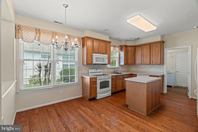 119 Glengarry Ln, Hainesport, NJ 08036 - kitchen featuring white appliances, a sink, light countertops, a chandelier, and brown cabinets