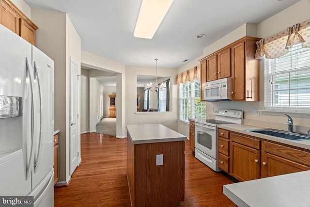 119 Glengarry Ln, Hainesport, NJ 08036 - kitchen featuring white appliances, a sink, brown cabinetry, dark wood-type flooring, and a chandelier