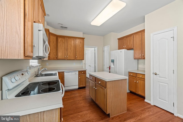 119 Glengarry Ln, Hainesport, NJ 08036 - kitchen with white appliances, a sink, wood finished floors, a center island, and light countertops