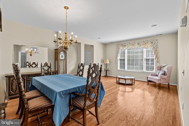 119 Glengarry Ln, Hainesport, NJ 08036 - dining area with a chandelier, wood finished floors, and baseboards