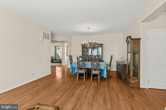 119 Glengarry Ln, Hainesport, NJ 08036 - dining area featuring light wood finished floors, baseboards, and a chandelier