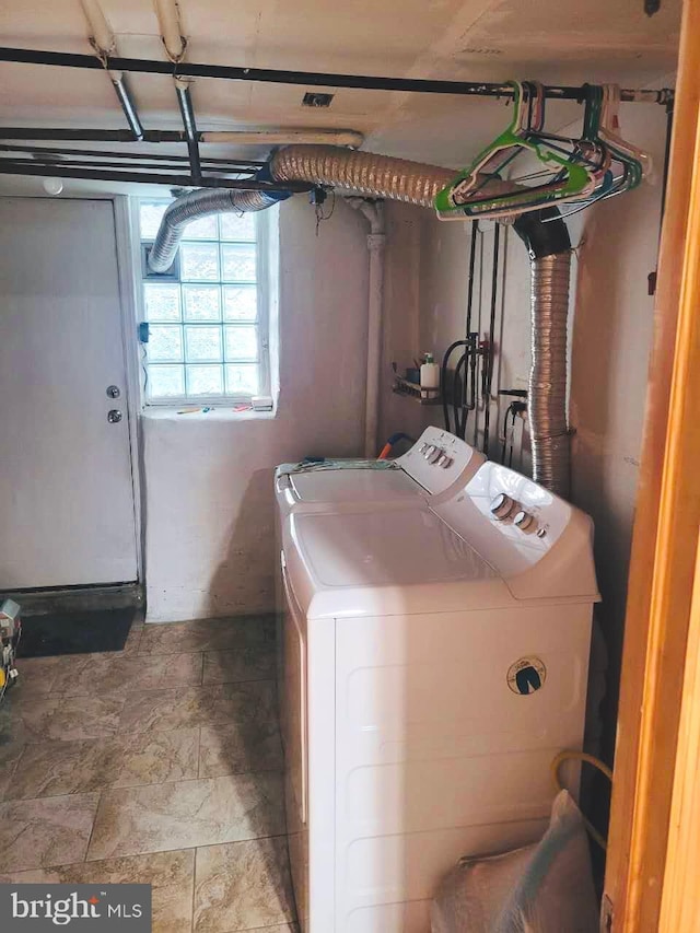 clothes washing area featuring laundry area and washer and dryer