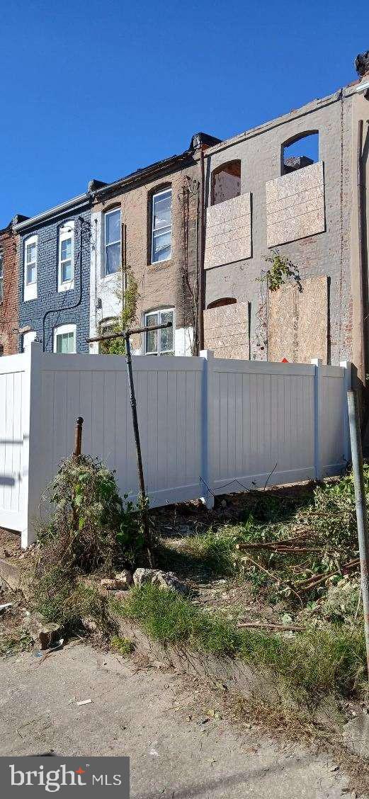 exterior space featuring stucco siding and fence