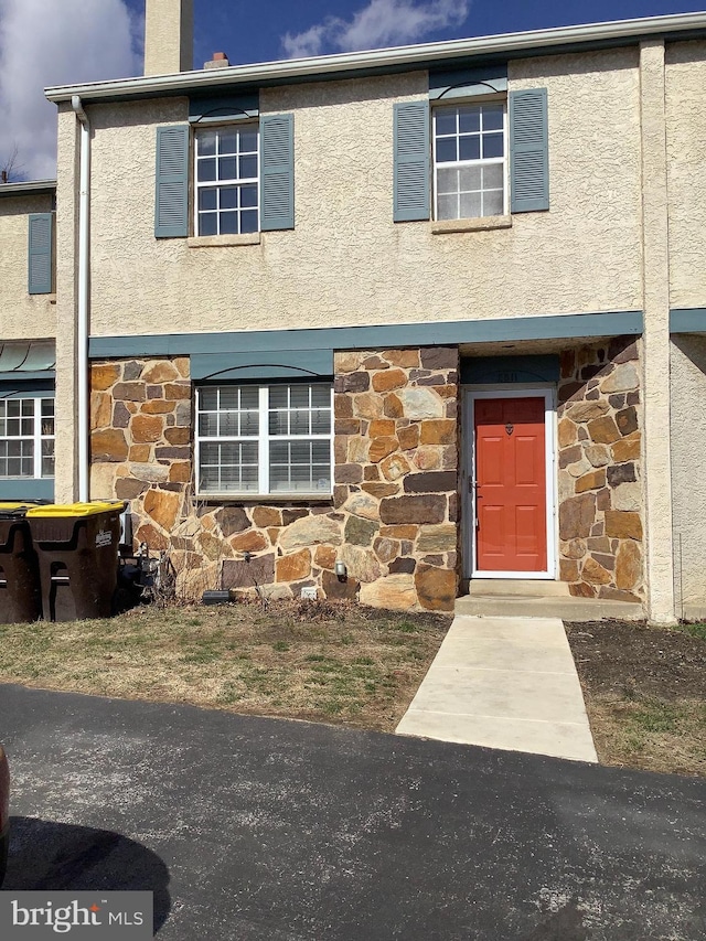 view of front of property with stone siding and stucco siding