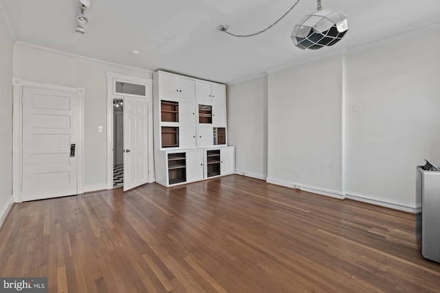 unfurnished living room featuring ornamental molding, dark wood finished floors, and baseboards