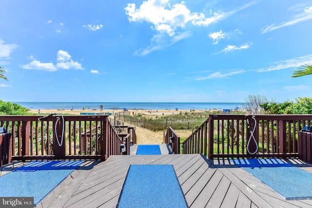 deck with a water view and a view of the beach