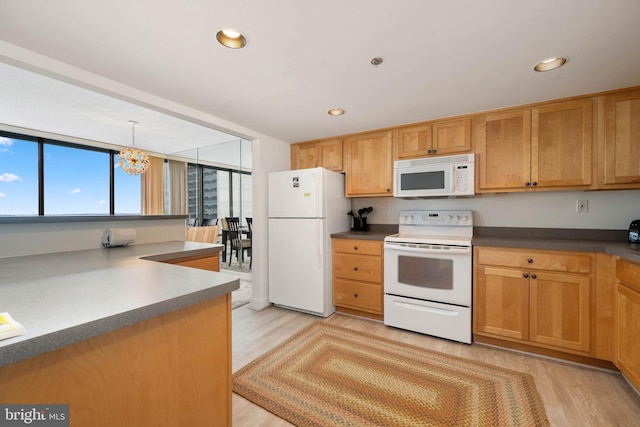 kitchen featuring white appliances, an inviting chandelier, light wood-type flooring, pendant lighting, and recessed lighting