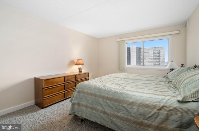 bedroom featuring baseboards and light colored carpet