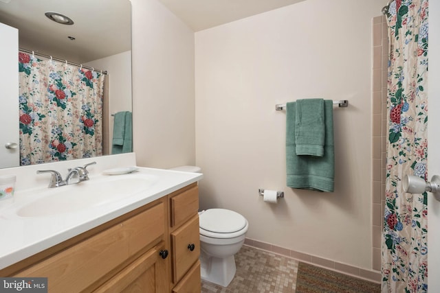 bathroom featuring tile patterned flooring, toilet, a shower with shower curtain, vanity, and baseboards