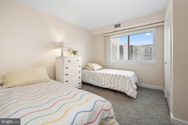 bedroom with carpet, visible vents, and baseboards