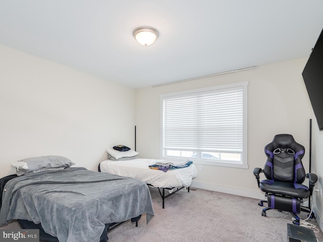 bedroom with baseboards and carpet