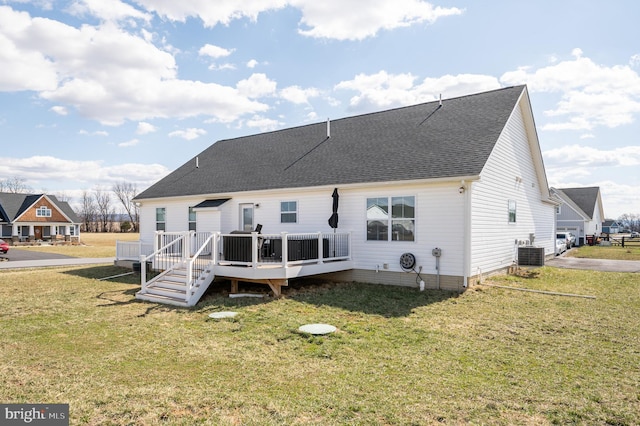 back of house featuring a yard, a wooden deck, central AC, and roof with shingles