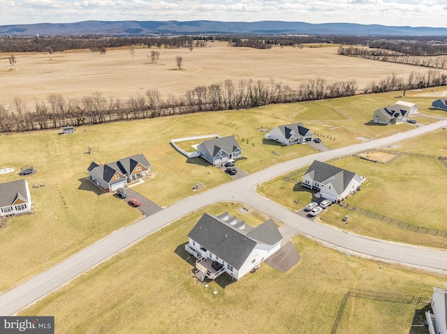 drone / aerial view featuring a rural view and a mountain view