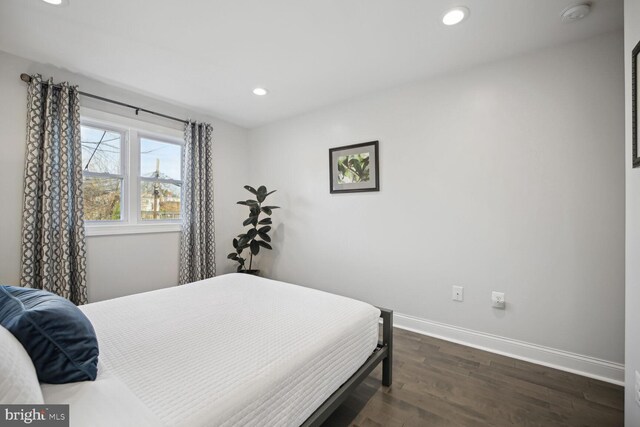 bedroom with recessed lighting, baseboards, and dark wood-type flooring