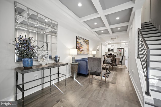 living area featuring stairway, wood finished floors, baseboards, coffered ceiling, and beam ceiling