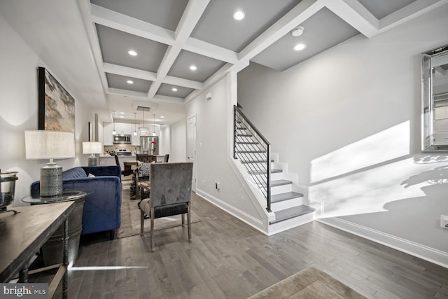 living area with beamed ceiling, coffered ceiling, dark wood finished floors, baseboards, and stairs