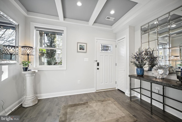 foyer with wood finished floors, baseboards, coffered ceiling, visible vents, and beam ceiling